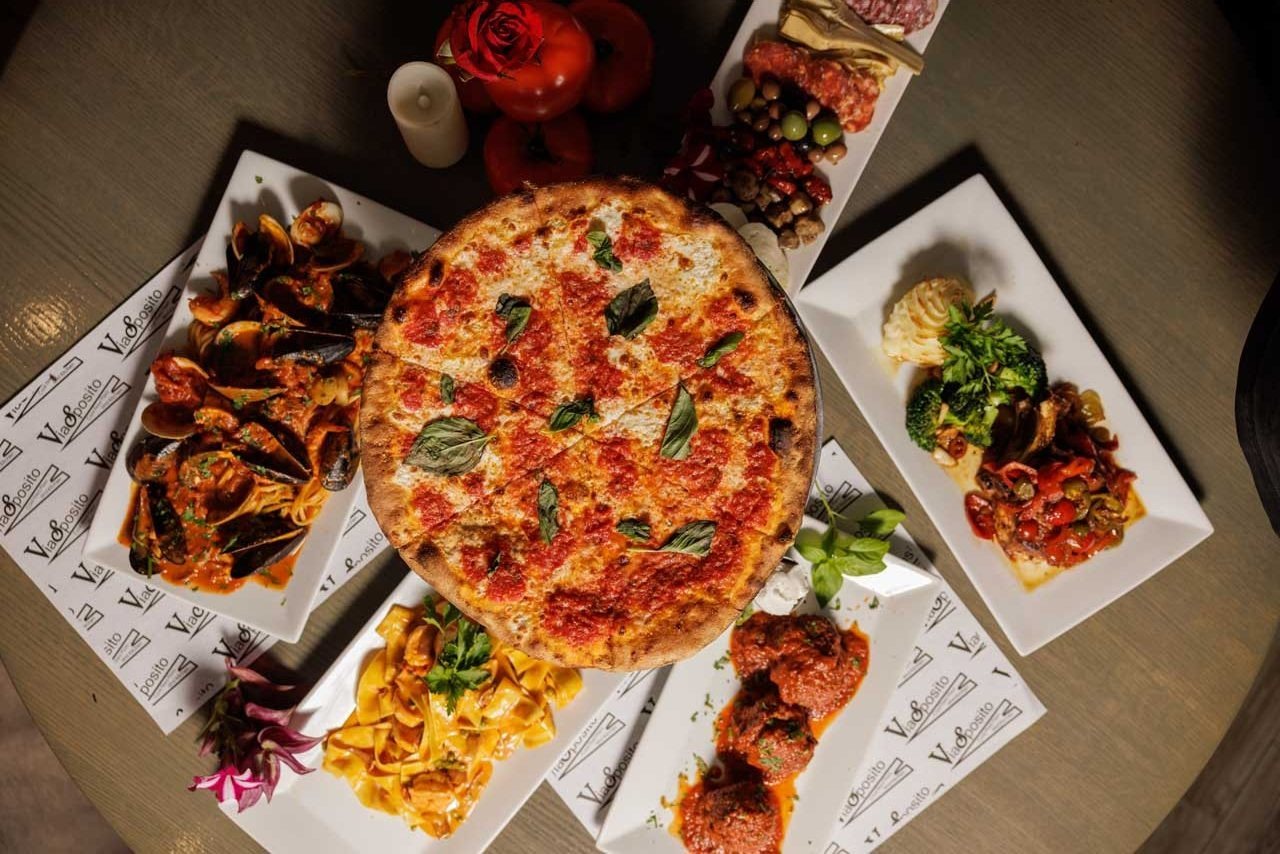 An overhead feast of coal-fired pizza, seafood pasta and antipasto