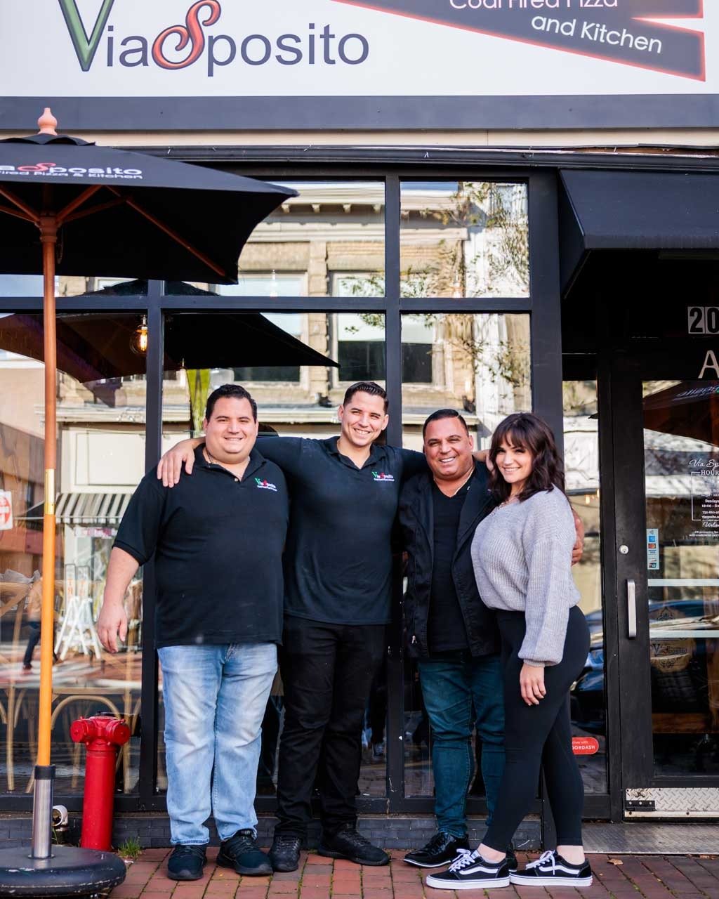 The Via Sposito family outside their storefront